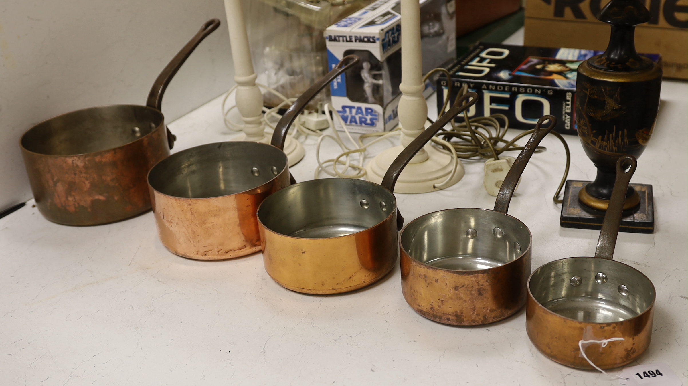 Five French copper graduated saucepans